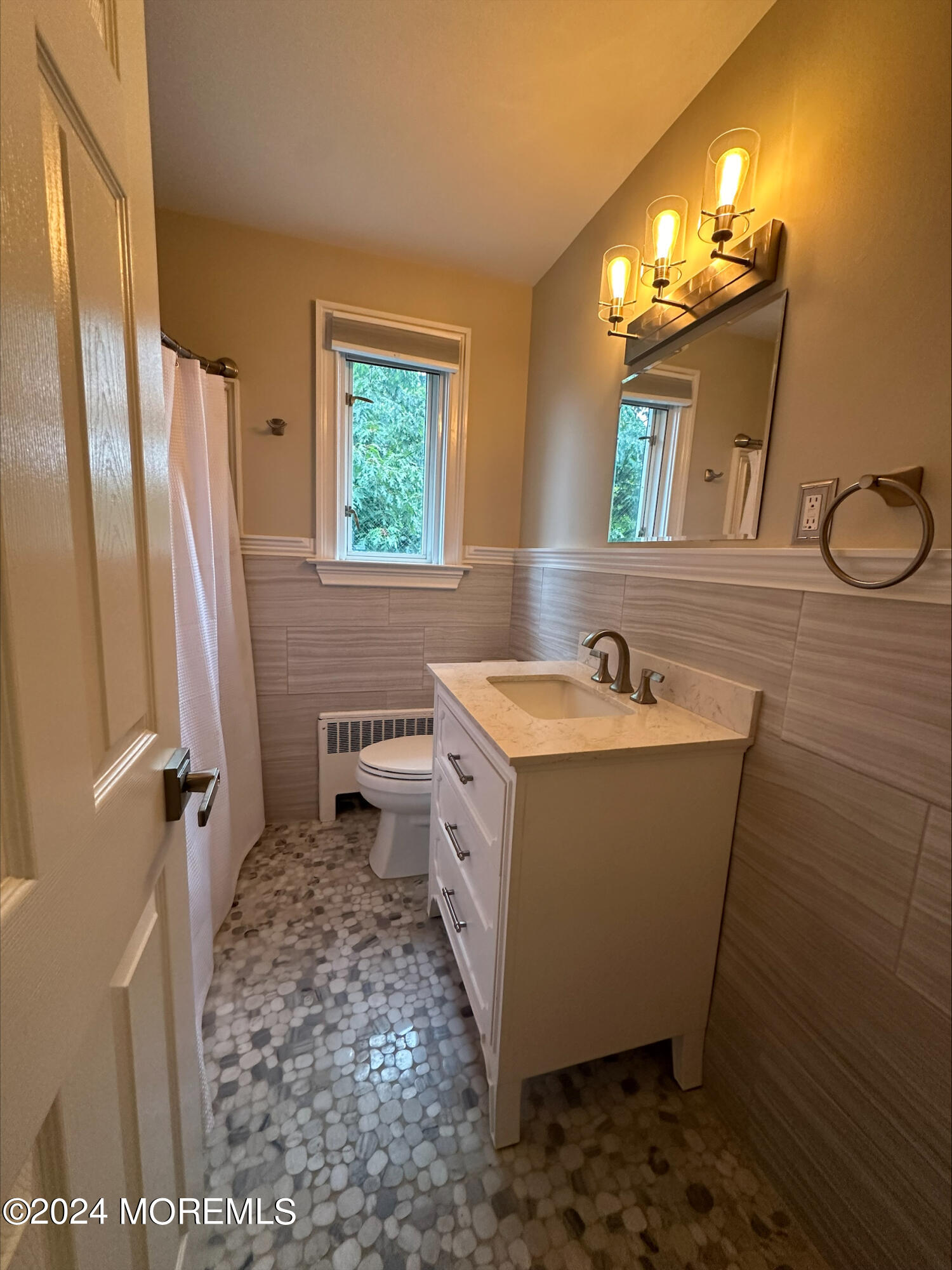 283 Spring Street, Unit 3D Red Bank, NJ 07701 - Photo 9 of 18 a bathroom with a sink a mirror and a shower