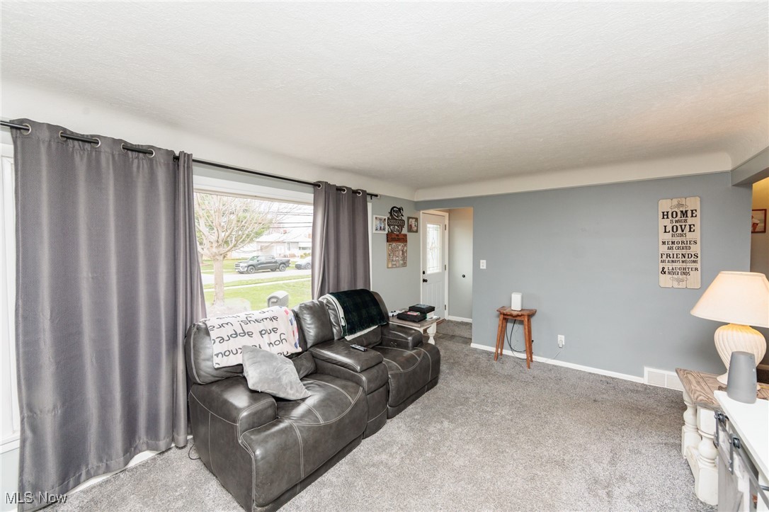 3443 Dentzler Road Parma, OH 44134 - Photo 12 of 48 Living room with baseboards, carpet flooring, and a textured ceiling