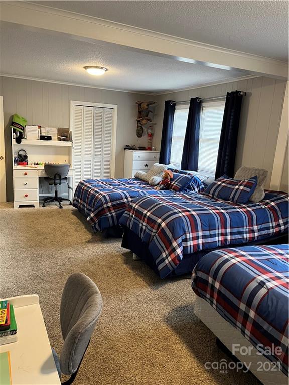 2419 Winfield Street Kannapolis, NC 28083 - Photo 12 of 25 a bedroom with a bed couch and a window