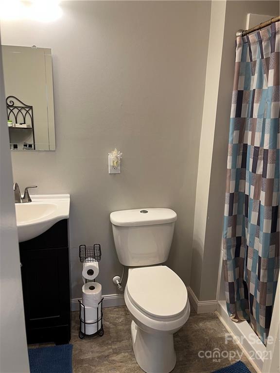 2419 Winfield Street Kannapolis, NC 28083 - Photo 13 of 25 a bathroom with a toilet sink and mirror