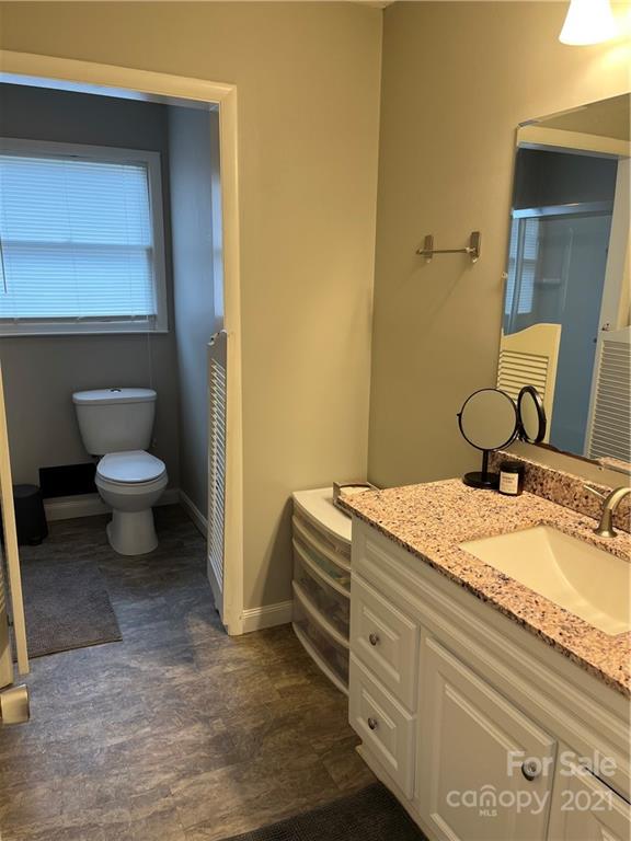 2419 Winfield Street Kannapolis, NC 28083 - Photo 15 of 25 a bathroom with a granite countertop sink and a mirror