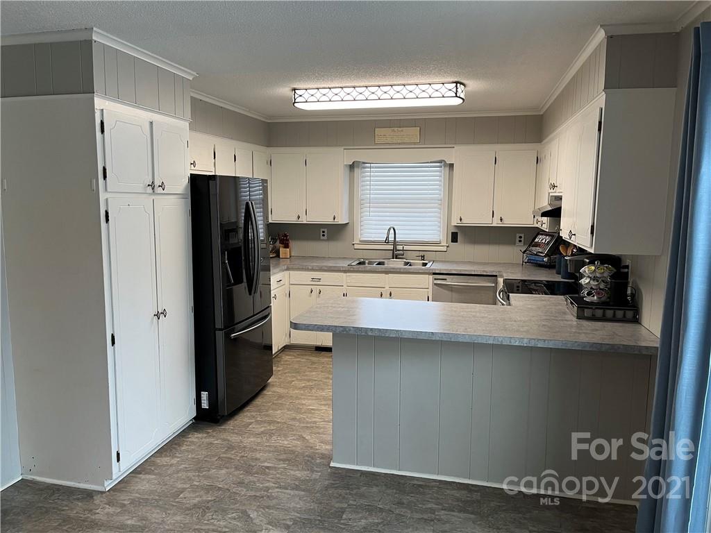 2419 Winfield Street Kannapolis, NC 28083 - Photo 4 of 25 a kitchen with stainless steel appliances a refrigerator and a stove