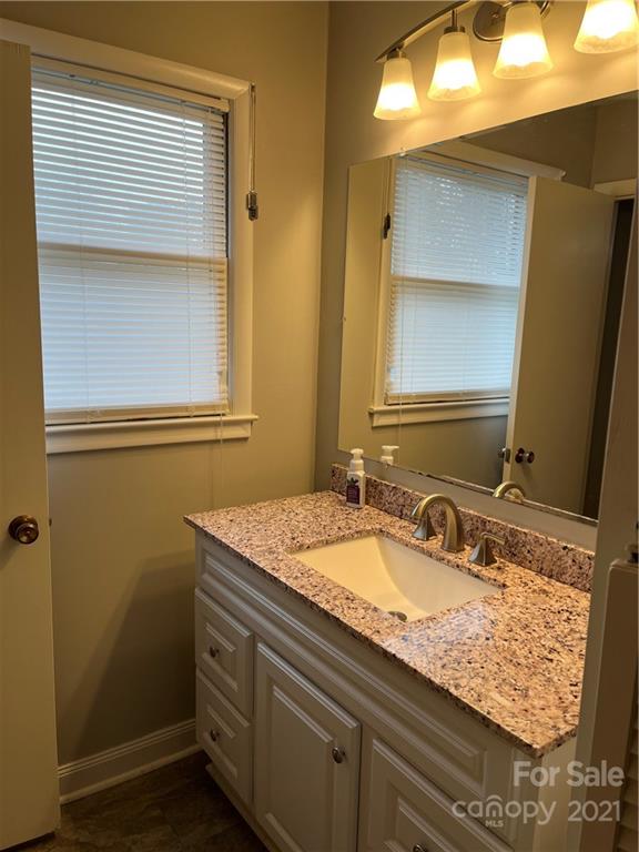 2419 Winfield Street Kannapolis, NC 28083 - Photo 9 of 25 a bathroom with a granite countertop sink and a mirror