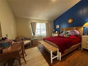 a bed room with a bed and a chair