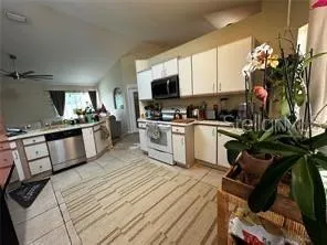 a kitchen with a sink appliances and cabinets