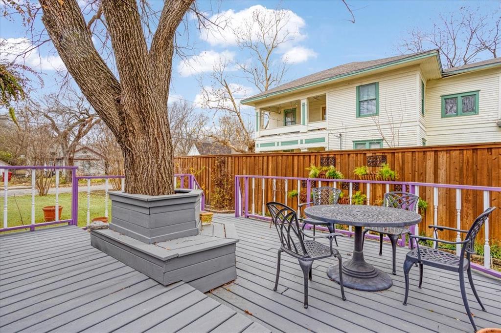 300 West 6th Street Bonham, TX 75418 - Photo 33 of 37 a view of a house with wooden deck and outdoor seating