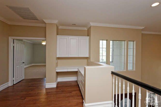 57 Highland Road Simi Valley, CA 93065 - Photo 13 of 46 a view of a hallway with wooden floor and a cabinet