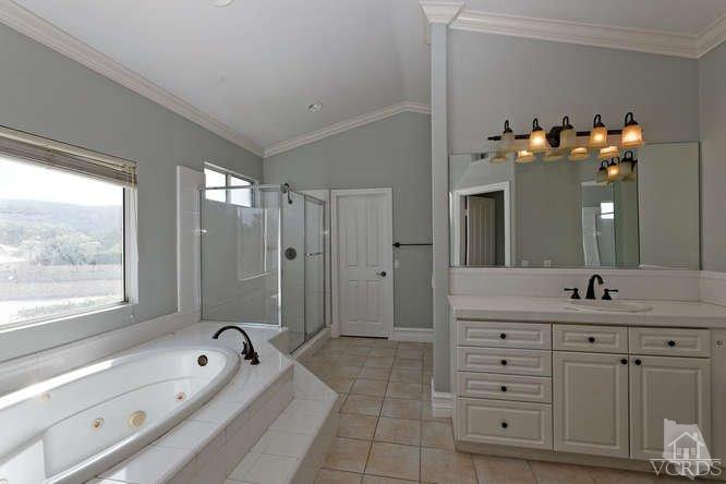 57 Highland Road Simi Valley, CA 93065 - Photo 16 of 46 a spacious bathroom with a double vanity sink a large mirror a bathtub and window