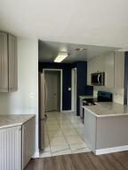 13529 42nd Road North West Palm Beach, FL 33411 - Photo 3 of 11 a kitchen with stainless steel appliances granite countertop a sink and a stove