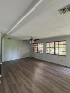 13529 42nd Road North West Palm Beach, FL 33411 - Photo 4 of 11 an empty room with wooden floor and windows
