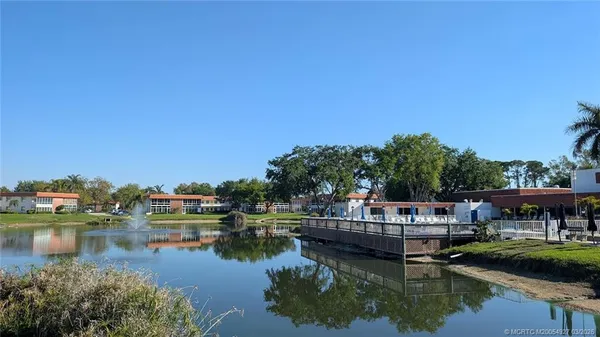 a balcony with outdoor seating and city view