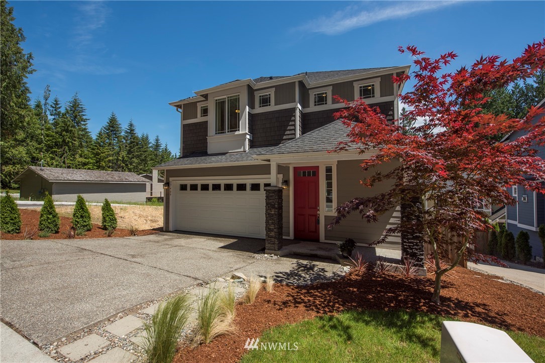 17409 3rd Avenue Southeast Bothell, WA 98012 - Photo 1 of 26 a front view of a house with a garden