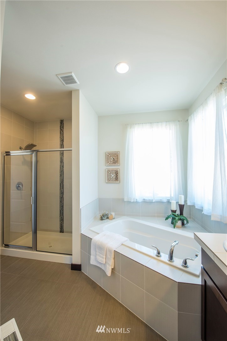 17409 3rd Avenue Southeast Bothell, WA 98012 - Photo 13 of 26 a bathroom with a bathtub a sink and a window