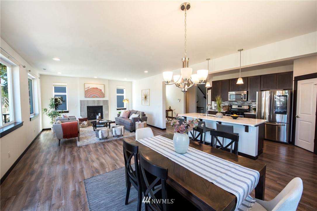 17409 3rd Avenue Southeast Bothell, WA 98012 - Photo 4 of 26 a view of a dining room and livingroom with furniture wooden floor a chandelier