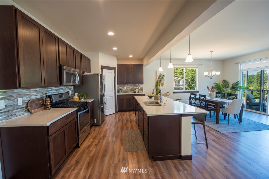 17409 3rd Avenue Southeast Bothell, WA 98012 - Photo 7 of 26 a kitchen with stainless steel appliances granite countertop sink stove top oven and cabinets