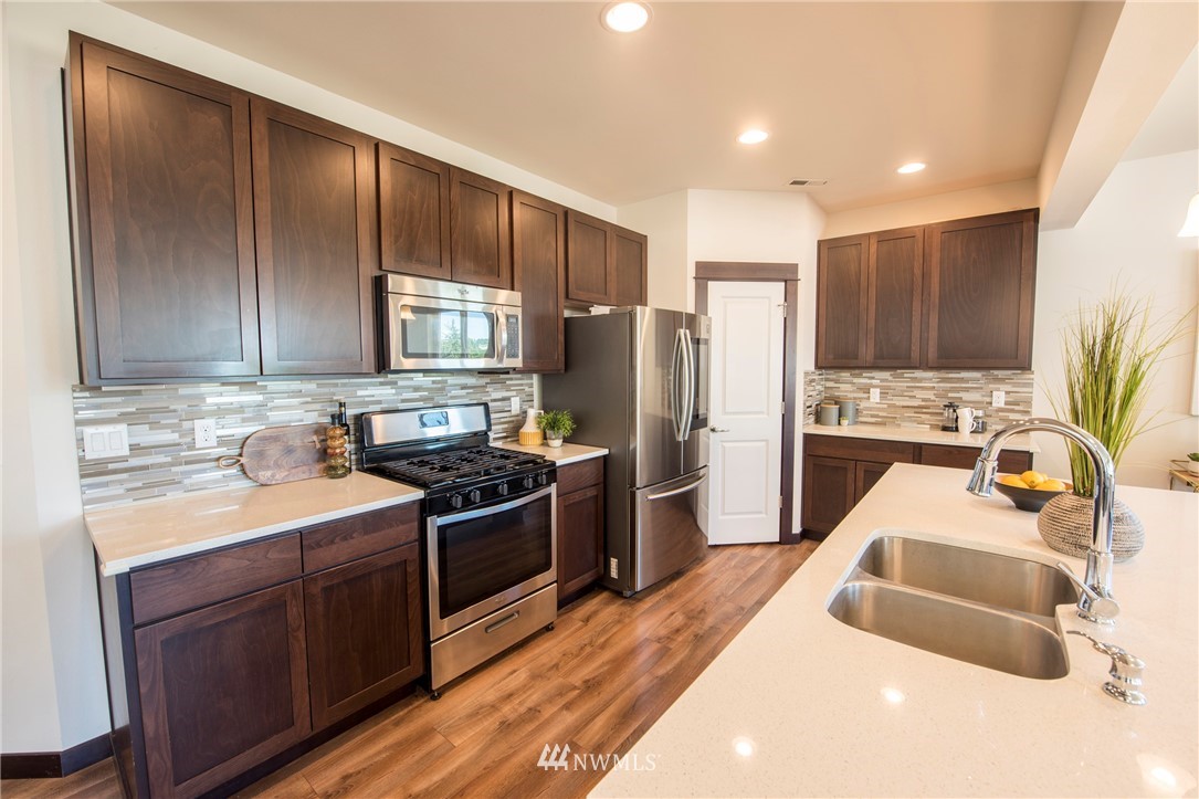 17409 3rd Avenue Southeast Bothell, WA 98012 - Photo 8 of 26 a kitchen with stainless steel appliances granite countertop a sink stove and refrigerator