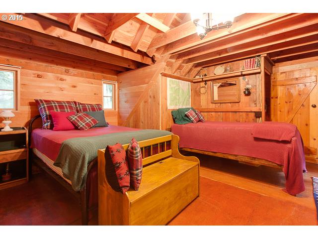 79546 Road 35 A, Unit 54 Rhododendron, OR 97049 - Photo 10 of 16 a bedroom with a bed and a night stand