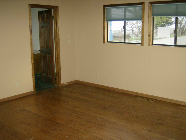 4061 Cienega Road Hollister, CA 95023 - Photo 18 of 25 an empty room with wooden floor and windows