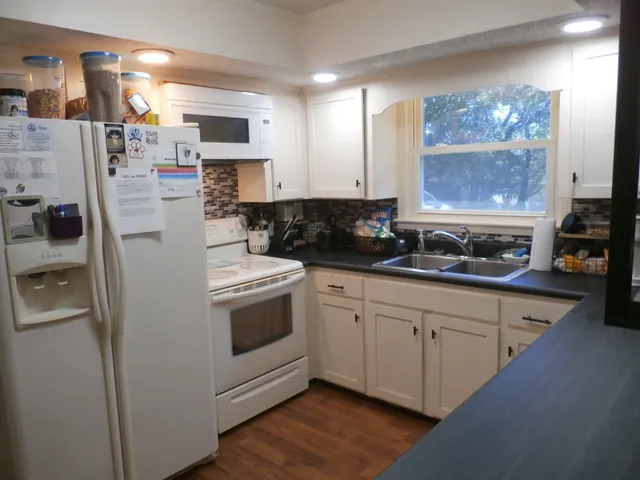 a kitchen with stainless steel appliances a stove a sink and a refrigerator
