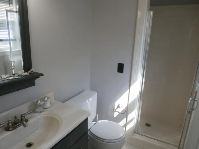 a bathroom with a sink toilet and shower