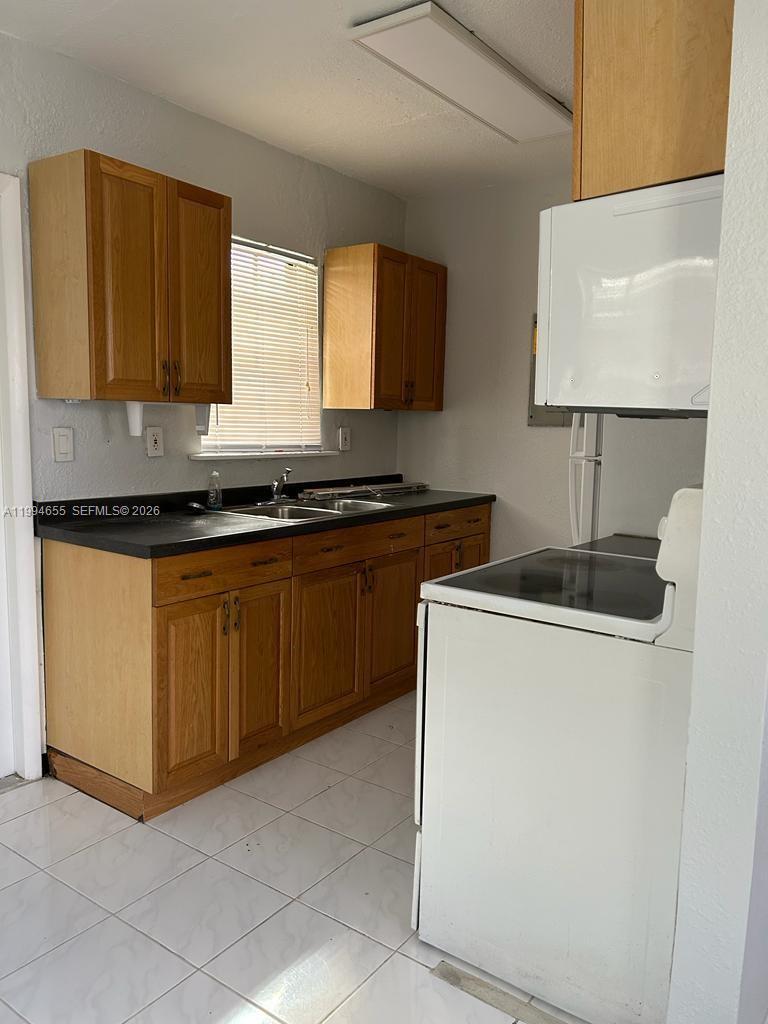 14735 Southwest 107th Avenue Miami, FL 33176 - Photo 3 of 9 a kitchen with stainless steel appliances granite countertop a sink and a stove