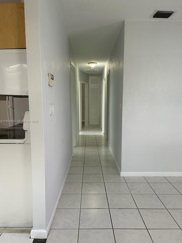 14735 Southwest 107th Avenue Miami, FL 33176 - Photo 4 of 9 a view of hallway with natural light