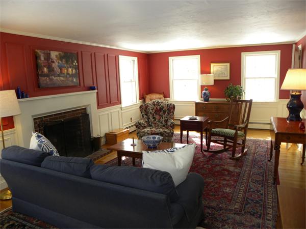 82 Ortins Road Hamilton, MA 01982 - Photo 9 of 25 a living room with furniture a large window and a fireplace