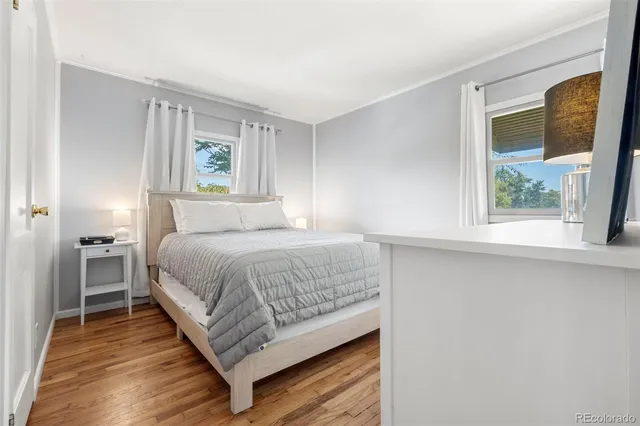 a bedroom with a bed lamp and a window