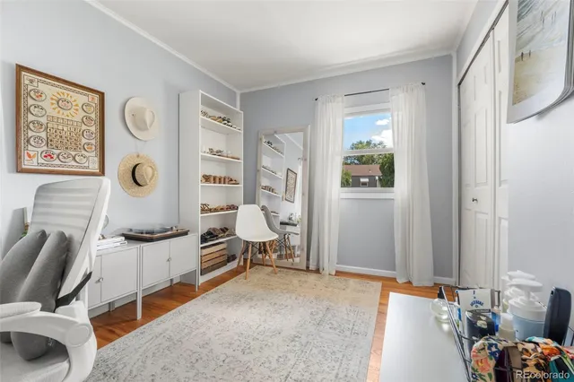 a bedroom with furniture and wooden floor