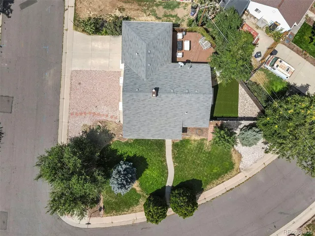 an aerial view of a house with a yard and a garage
