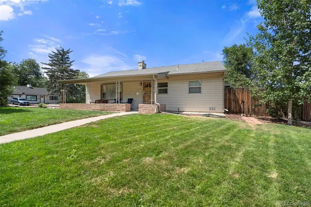 a view of a house with a backyard porch and sitting area