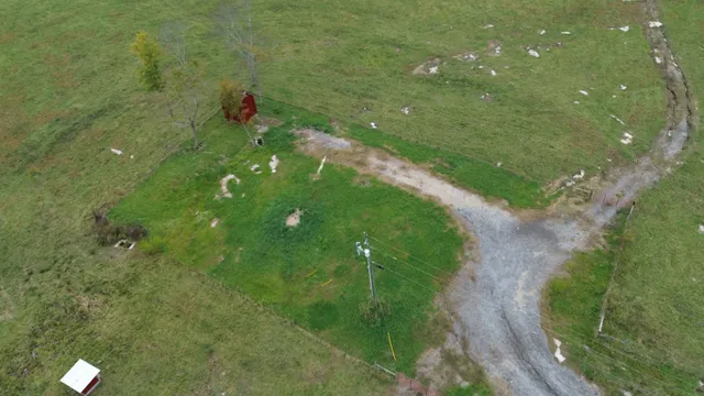 a backyard of a house with a yard and outdoor seating