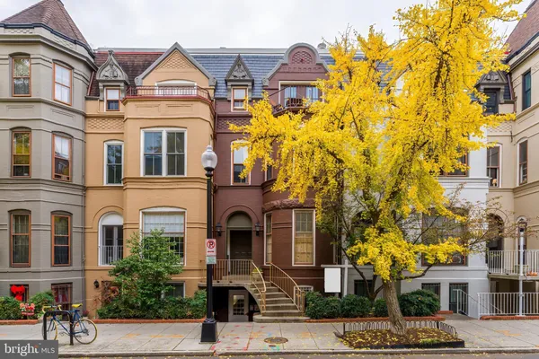 a view of a brick building next to a road