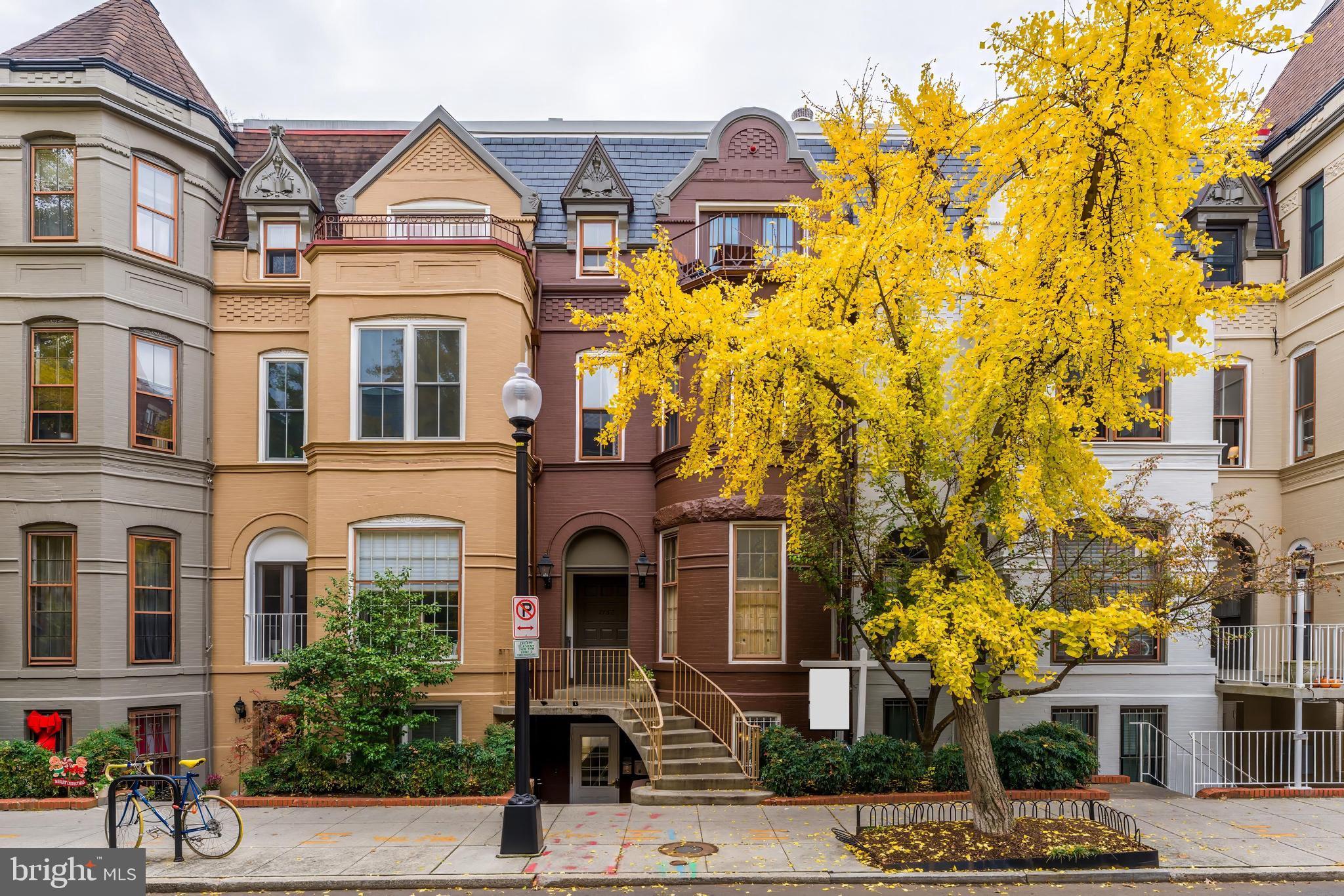 a view of a brick building next to a road