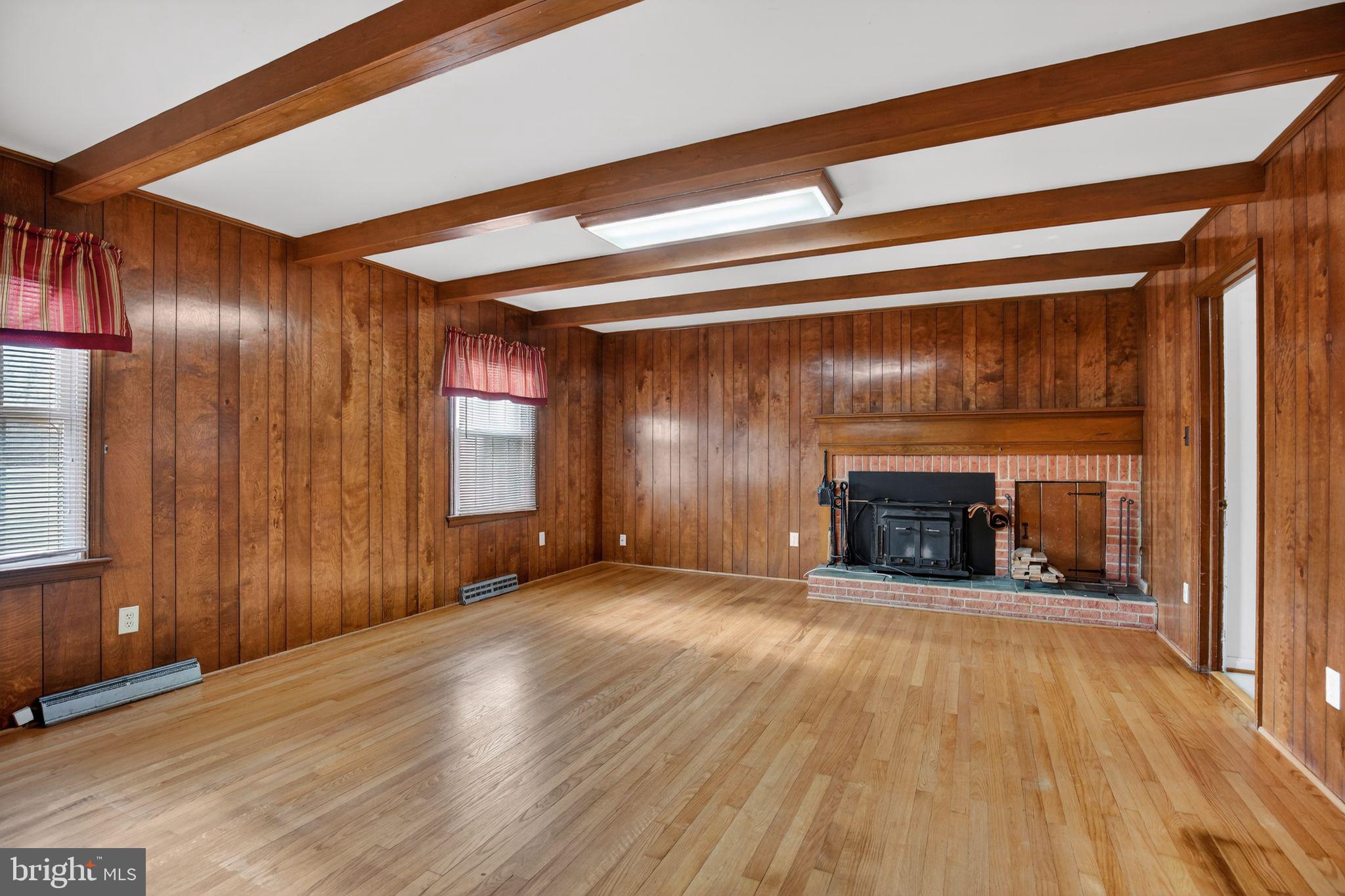 7146 Leonardtown Road Hughesville, MD 20637 - Photo 12 of 34 a view of an empty room with wooden floor and a window
