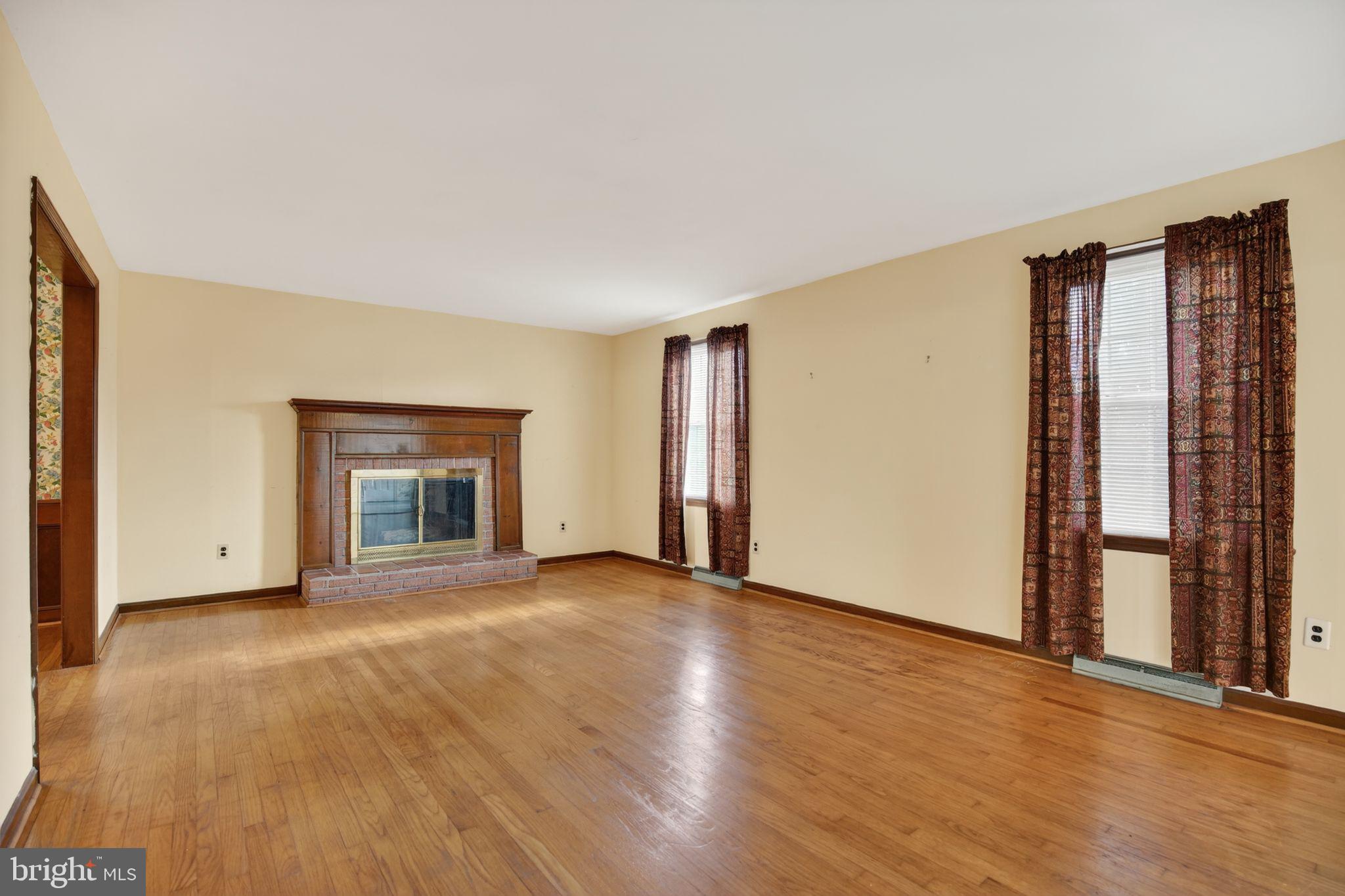 7146 Leonardtown Road Hughesville, MD 20637 - Photo 14 of 34 a view of an empty room with a window and fireplace
