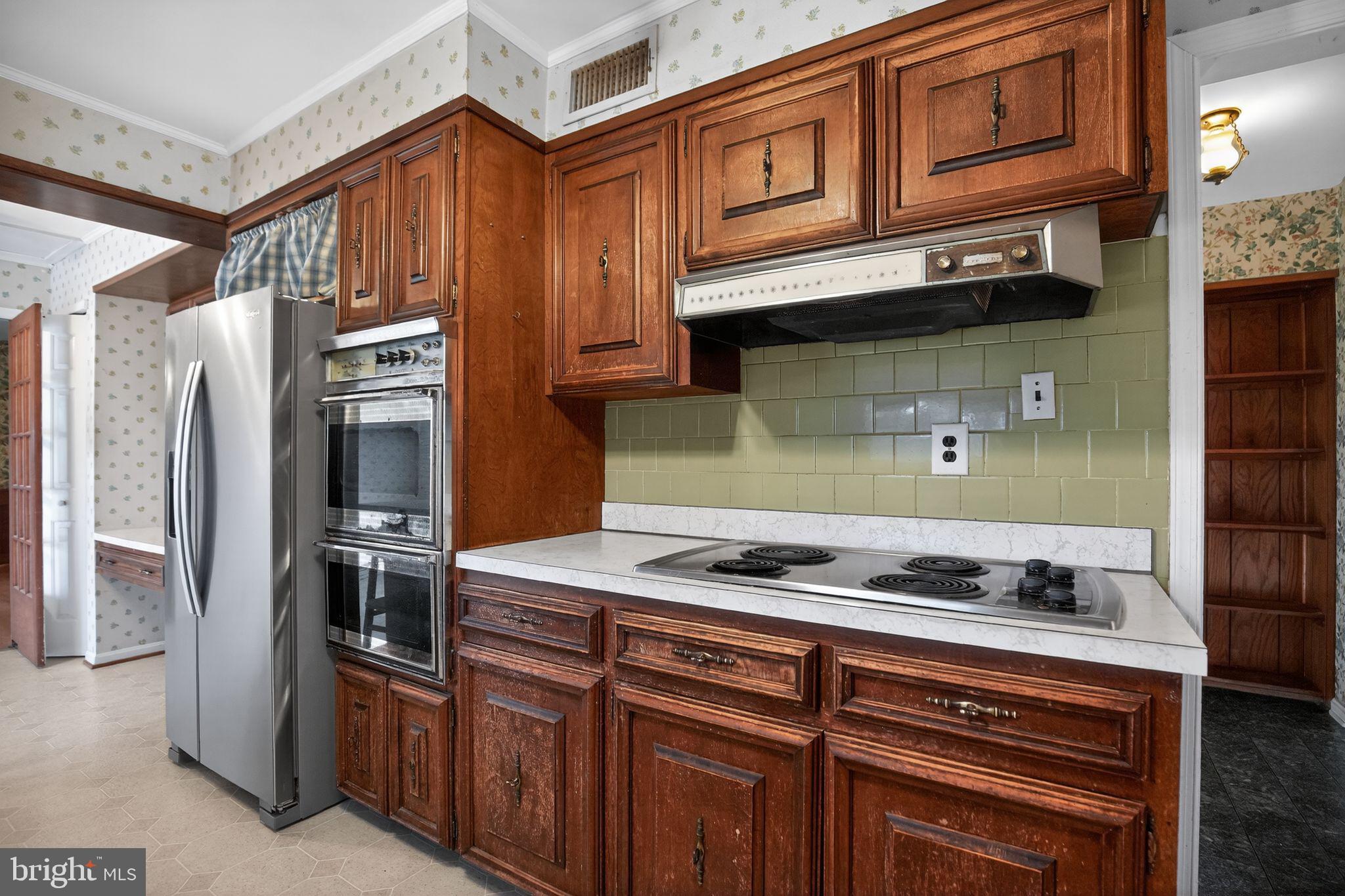 7146 Leonardtown Road Hughesville, MD 20637 - Photo 19 of 34 a kitchen with stainless steel appliances granite countertop a stove and a refrigerator