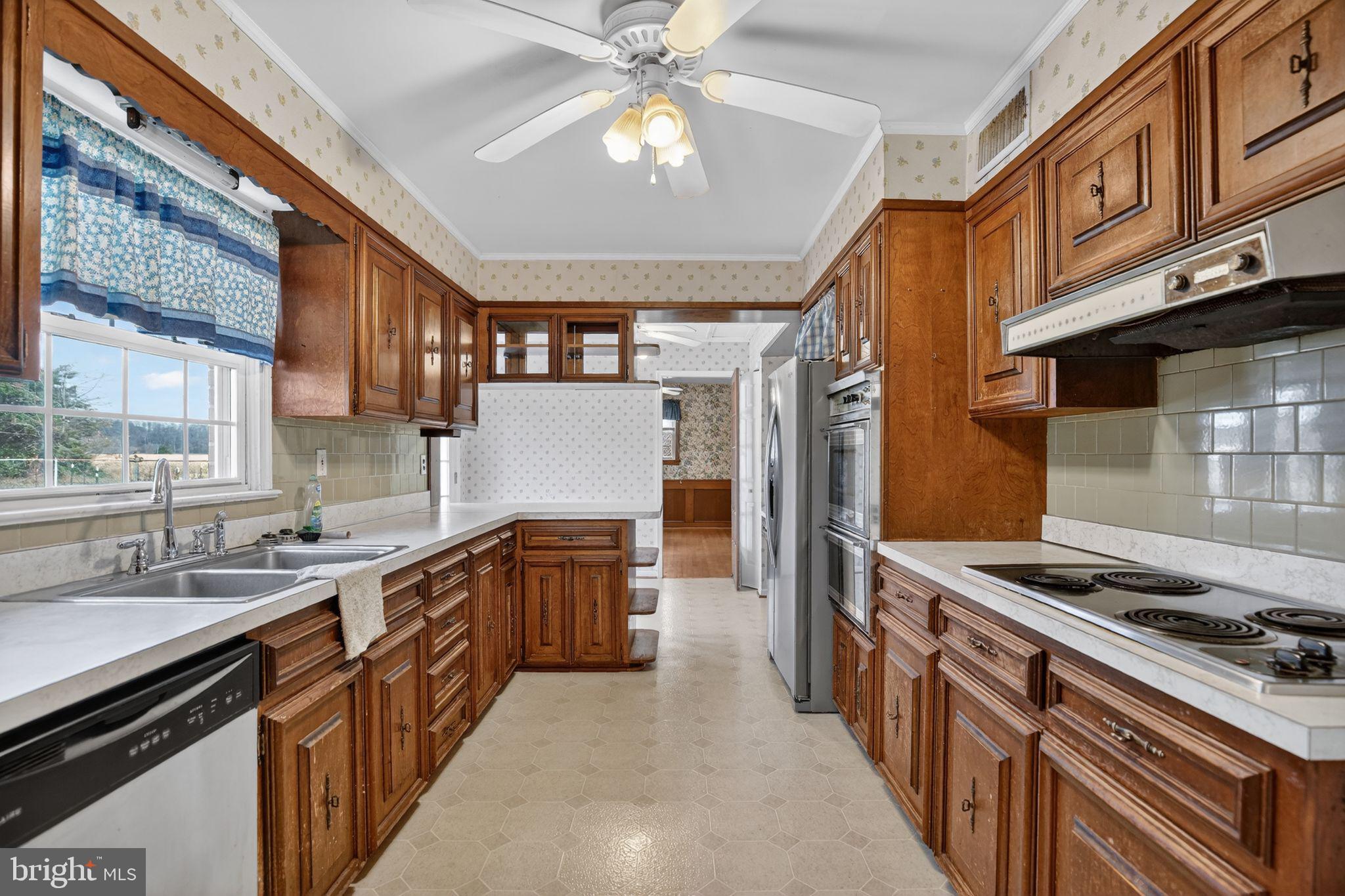 7146 Leonardtown Road Hughesville, MD 20637 - Photo 22 of 34 a kitchen with stainless steel appliances granite countertop a stove and a sink