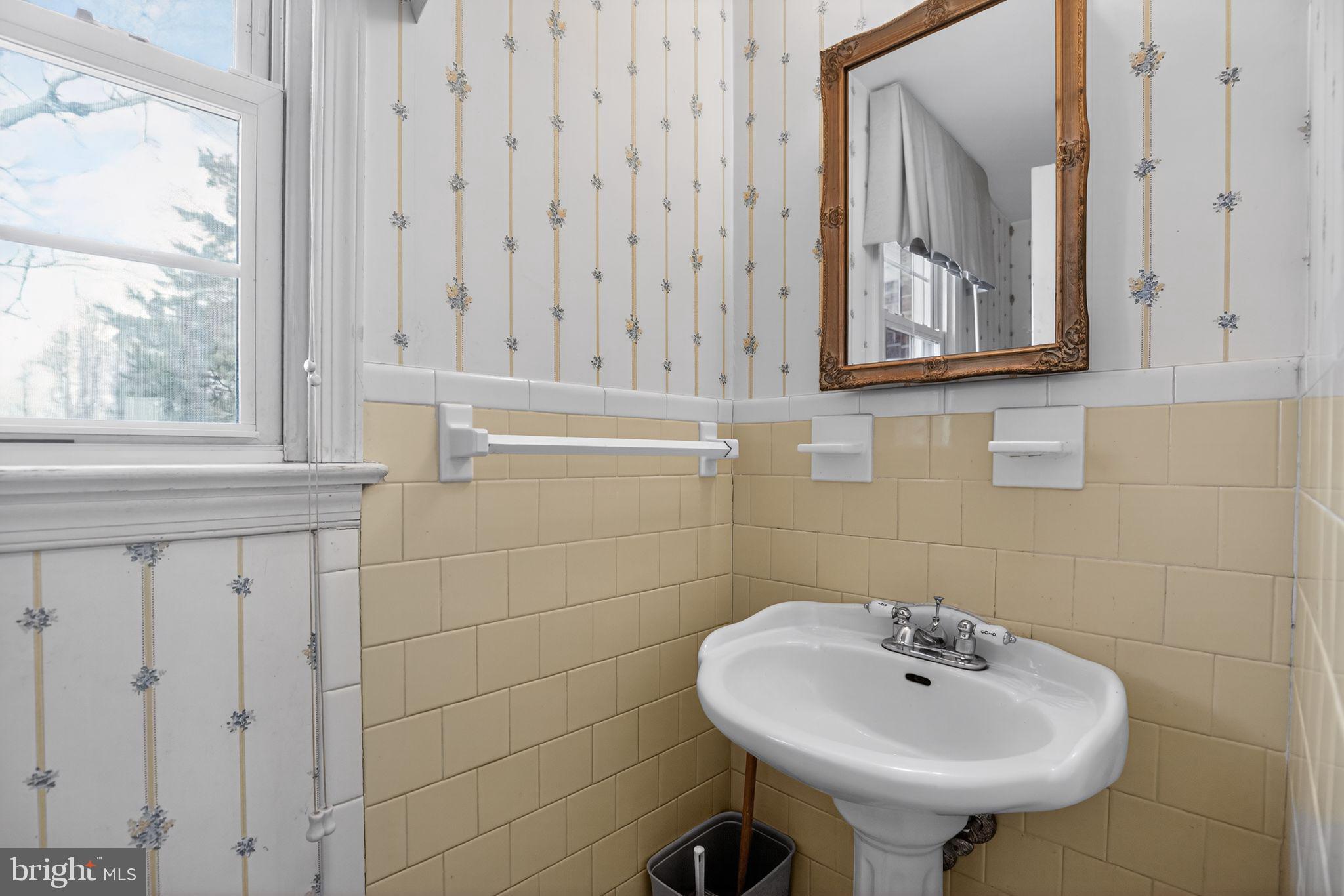7146 Leonardtown Road Hughesville, MD 20637 - Photo 25 of 34 a bathroom with a sink a mirror and a window