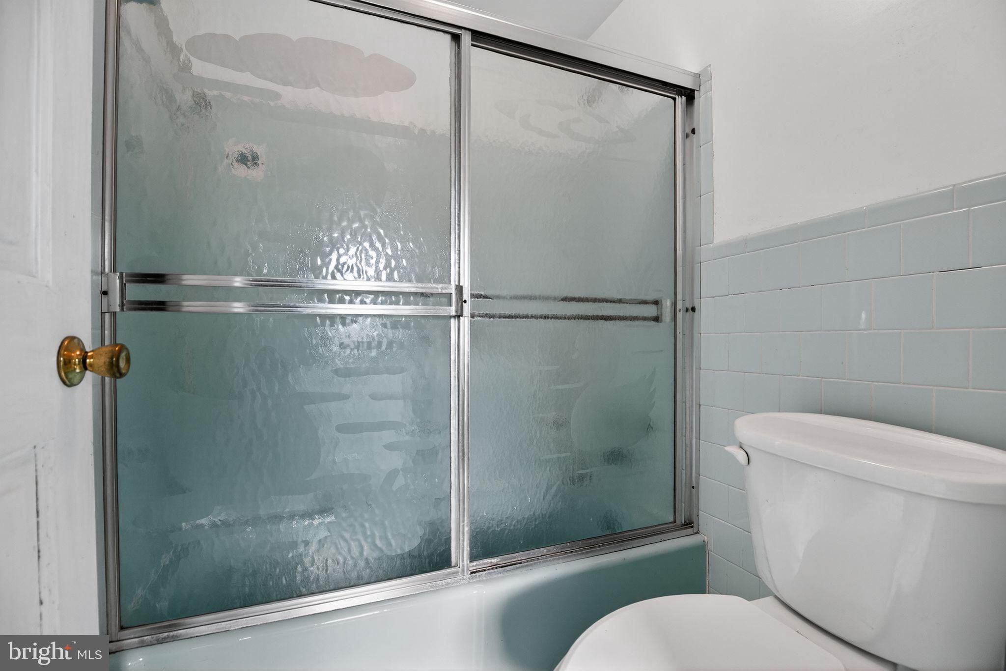 7146 Leonardtown Road Hughesville, MD 20637 - Photo 31 of 34 a bathroom with a shower a toilet and a sink