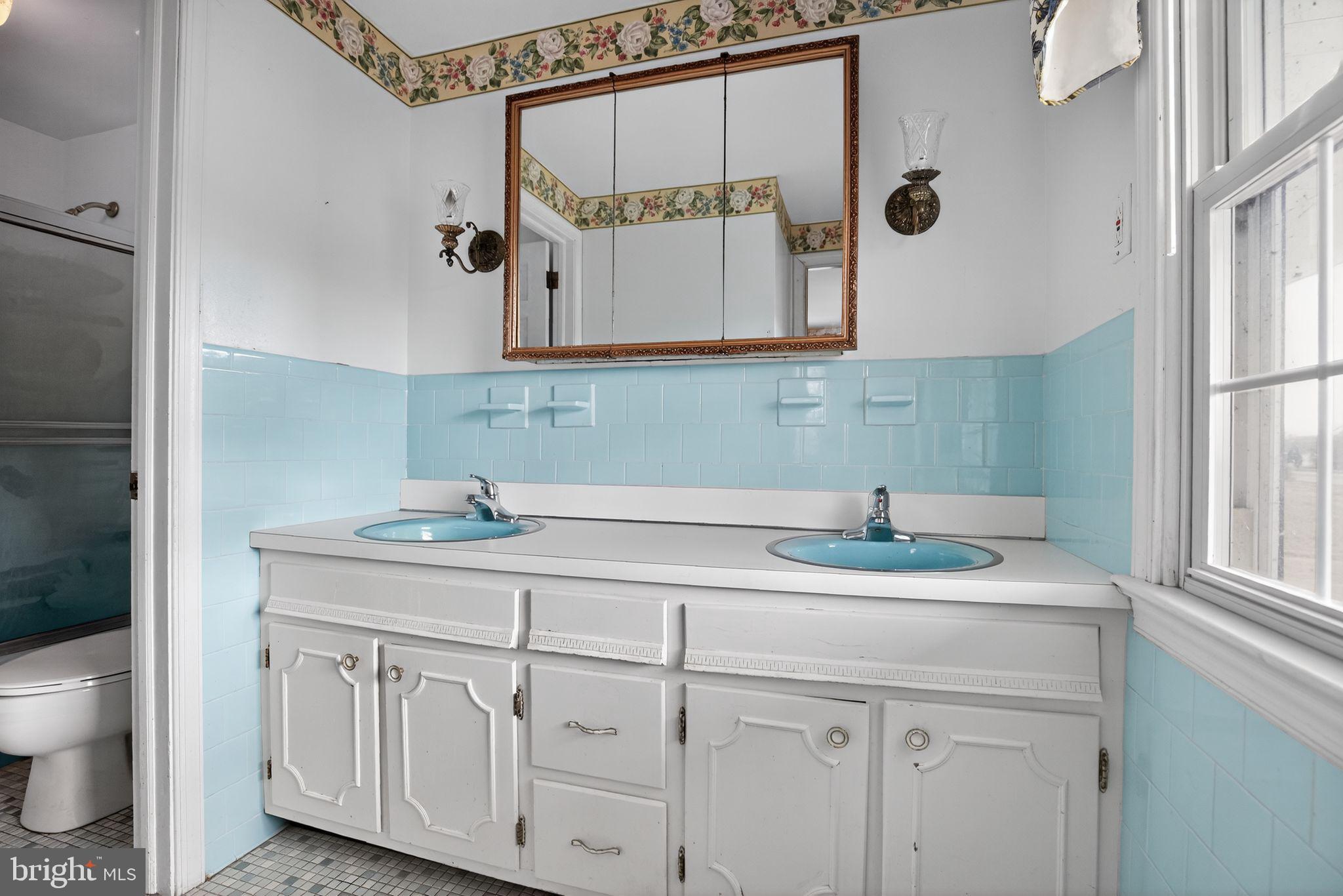 7146 Leonardtown Road Hughesville, MD 20637 - Photo 32 of 34 a bathroom with a granite countertop sink mirror and toilet