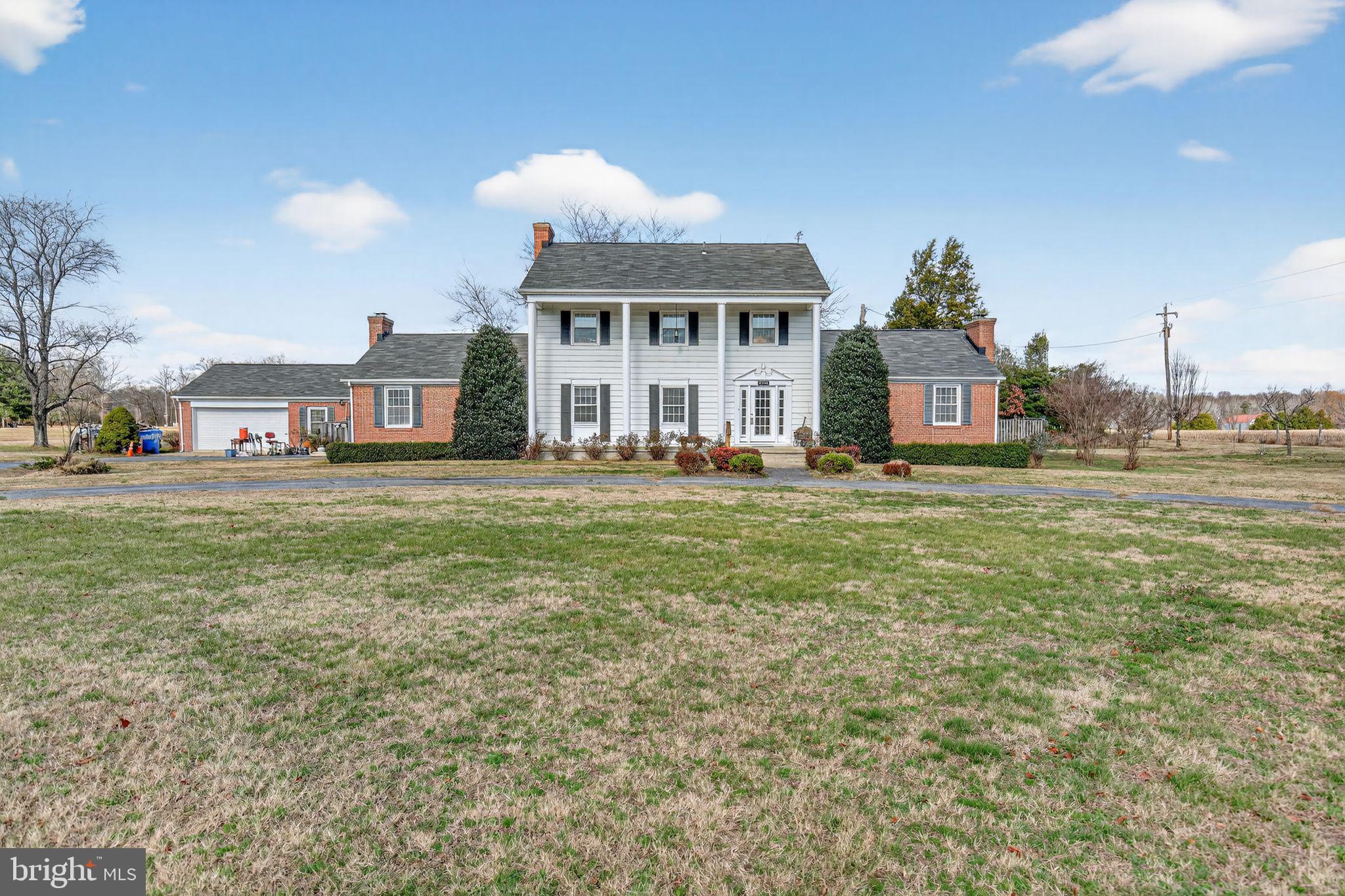 7146 Leonardtown Road Hughesville, MD 20637 - Photo 8 of 34 a front view of a house with a garden and trees