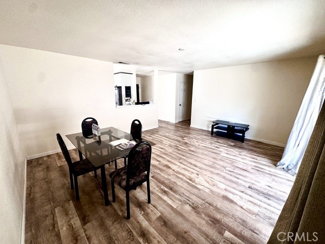 1050 Athena Court Riverside, CA 92507 - Photo 11 of 12 a view of a dining room with furniture and wooden floor
