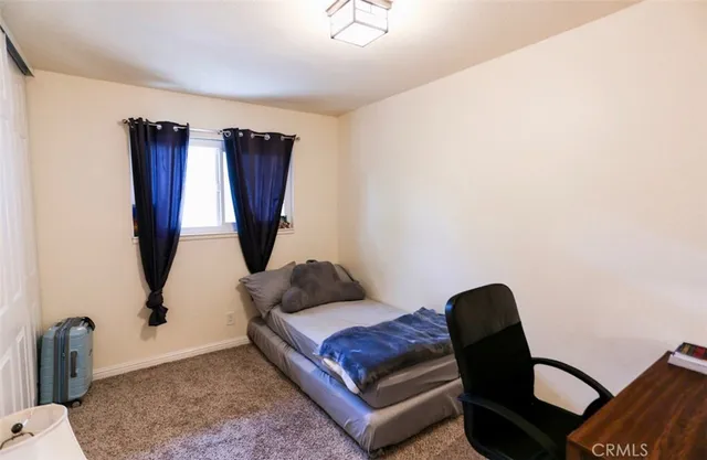 a living room with furniture rug and a window