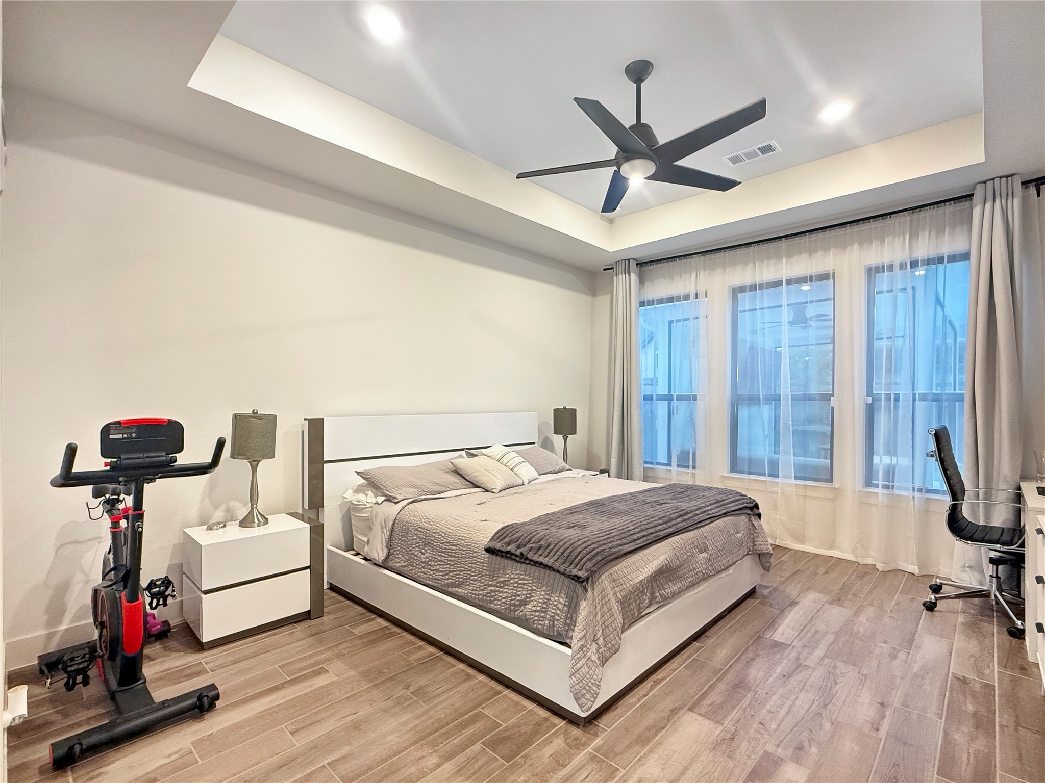 26918 Swanborough Road Spring, TX 77389 - Photo 19 of 50 Spacious Primary suite with backyard views, featuring tray ceiling, abundant natural light, and ample room for a sitting area.