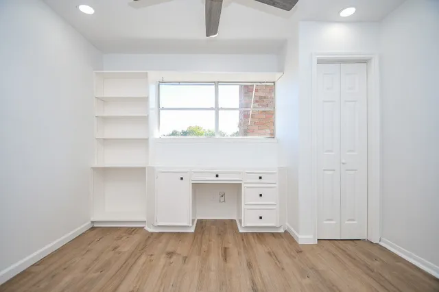 a view of an empty room with wooden floor