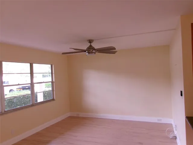 an empty room with a empty space and windows