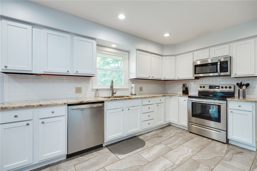 6950 Red Lion 5 Points Road Springboro, OH 45066 - Photo 20 of 78 Bright and airy kitchen featuring sleek countertops, modern appliances, and ample cabinet storage.
