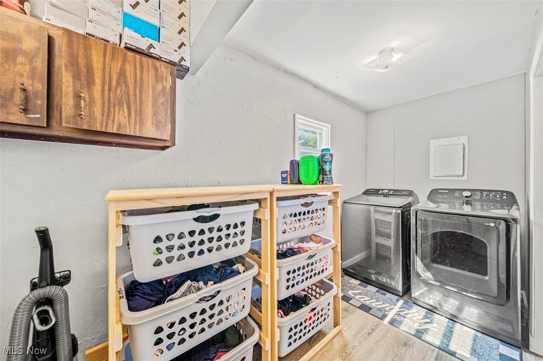 1864 Green Road Madison, OH 44057 - Photo 15 of 29 Clothes washing area featuring light hardwood / wood-style flooring, independent washer and dryer, and cabinets