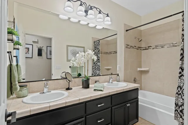 a bathroom with a double vanity sink mirror and double
